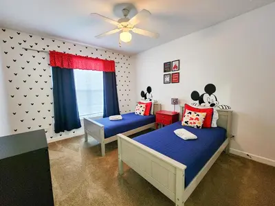 a bedroom with two beds and a ceiling fan at Retreat at Secret Lake 10 mins to Disney in Kissimmee