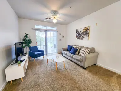 a living room with a couch and a tv at Retreat at Secret Lake 10 mins to Disney in Kissimmee