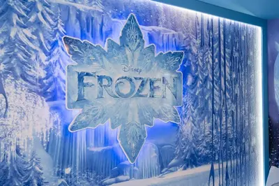 a sign that says frozen on a wall at Family Fun with Mickey and Frozen at Storey Lake in Kissimmee