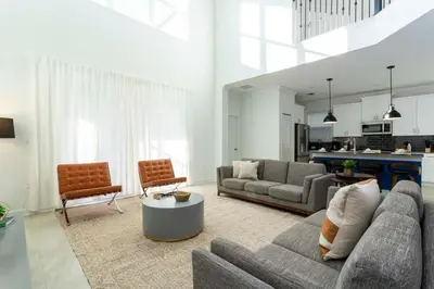 a living room with a couch and a table at Super Luxury Modern Home, Prime Location in Kissimmee