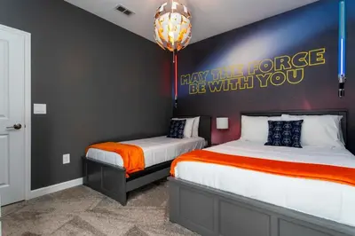 a bedroom with two beds and a sign on the wall at Super Luxury Modern Home, Prime Location in Kissimmee