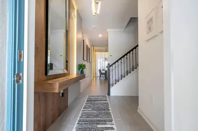 a hallway of a home with a rug on the floor at WonderFul 4Bd w Pool Close to Disney at StoreyLake 2669 in Kissimmee