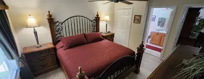 a bedroom with a large bed with a red blanket at Emerald Island Diamond on the Island in Kissimmee