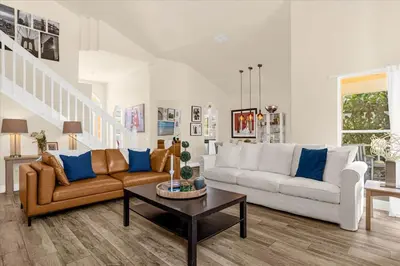a living room with a couch and a table at Luxury 4BR Home at Ventura Golf and Country Club in Orlando