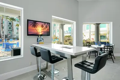 a dining room with a white table and chairs at 5 Minutes to Disney Free Shuttle King & queen bed in Orlando