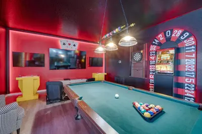 a billiard room with a pool table and a arcade at Kissimmee Oasis with Resort Perks! in Kissimmee