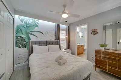 a bedroom with a bed with a painting on the wall at Kissimmee Oasis with Resort Perks! in Kissimmee