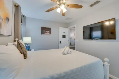 a bedroom with a white bed with a ceiling fan at Kissimmee Oasis with Resort Perks! in Kissimmee