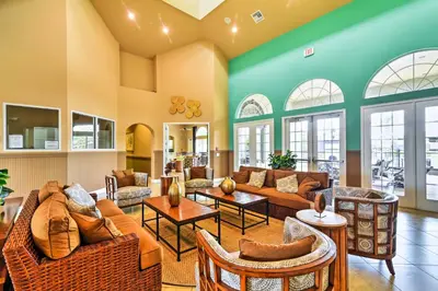 a living room with couches and tables at Kissimmee Oasis with Resort Perks! in Kissimmee