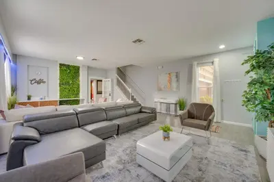 a living room with a large couch and chairs at Kissimmee Oasis with Resort Perks! in Kissimmee