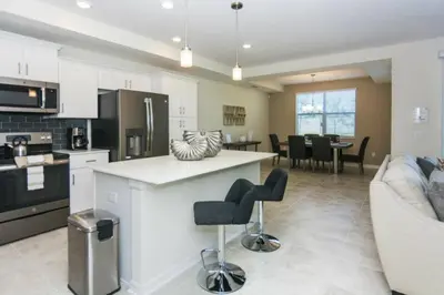 a kitchen and living room with a couch and a table at Premium Apartment 2BR2BA • Near Disney • PoolLazy River at Storey Lake Resort SL47316 in Kissimmee