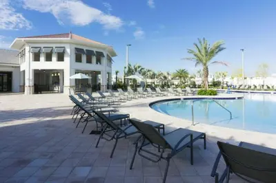a group of chairs sitting next to a swimming pool at Premium Apartment 2BR2BA • Near Disney • PoolLazy River at Storey Lake Resort SL47316 in Kissimmee