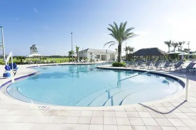 a large swimming pool with chairs in a resort at Premium Apartment 2BR2BA • Near Disney • PoolLazy River at Storey Lake Resort SL47316 in Kissimmee