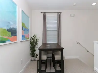 a table with chairs in a room with a painting at Luxurious Villa 9br Encore Resort near to Disney in Orlando