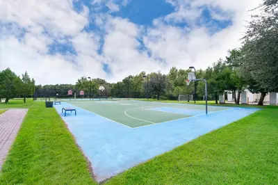a basketball court in a park with a basketball hoop at Enchanted Townhome near Disney Parks 3Br in Kissimmee