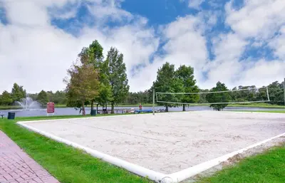 a volleyball court with a net in a park at Enchanted Townhome near Disney Parks 3Br in Kissimmee