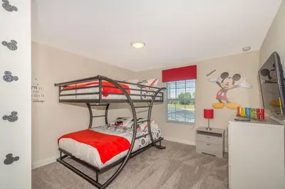 a bedroom with two bunk beds and a desk at Stunning Townhouses 5 Minutes away Disney! in Kissimmee