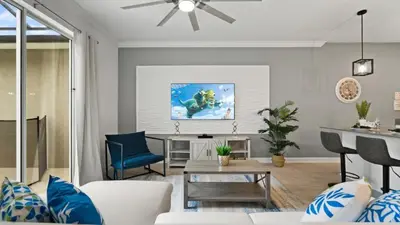 a living room with a couch and a table at Stunning Townhouses 5 Minutes away Disney! in Kissimmee