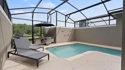 an indoor swimming pool with a glass roof at Stunning Townhouses 5 Minutes away Disney! in Kissimmee