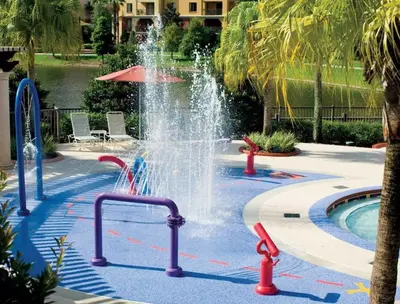 a fountain in the middle of a swimming pool at Bonnet Creek 2 Bedroom Deluxe in Orlando