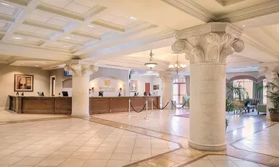 a large lobby with columns and a bar at Bonnet Creek 2 Bedroom Deluxe in Orlando