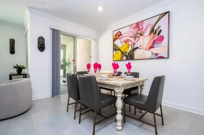 a dining room with a table and chairs at Gorgeous 4 Bd w Pool at Storey Lake Resort 2485 in Kissimmee