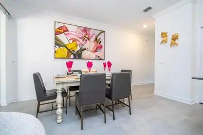 a dining room with a table with chairs and a painting at Gorgeous 4 Bd w Pool at Storey Lake Resort 2485 in Kissimmee