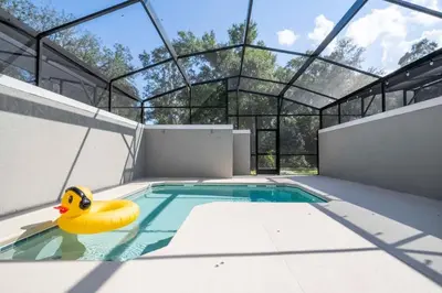 a swimming pool with a rubber duck in the water at Gorgeous 4 Bd w Pool at Storey Lake Resort 2485 in Kissimmee