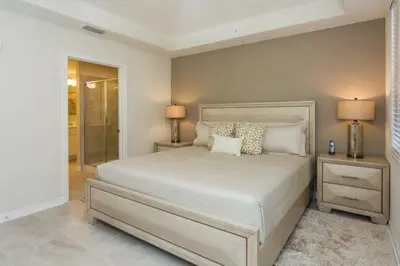 a bedroom with a bed with two night stands and two lamps at Elegant Apartment 3BR2BA • Near Disney • PoolLazy River at Storey Lake Resort SL47318 in Kissimmee