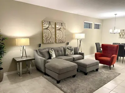 a living room with a couch and a chair at Elegant Apartment 3BR2BA • Near Disney • PoolLazy River at Storey Lake Resort SL47318 in Kissimmee