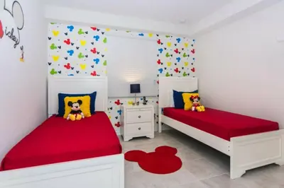 two beds in a white room with red sheets at Spacious Apartment 2BR2BA • Near Disney • PoolLazy River at Storey Lake Resort SL47317 in Kissimmee
