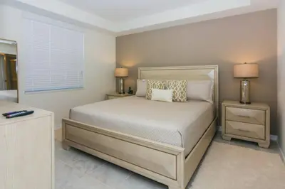 a bedroom with a bed with two night stands and two lamps at Spacious Apartment 2BR2BA • Near Disney • PoolLazy River at Storey Lake Resort SL47317 in Kissimmee