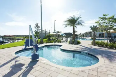 a pool at a resort with palm trees at Modern Apartment 2BR2BA • Near Disney • Storey Lake Resort SL47314 in Kissimmee
