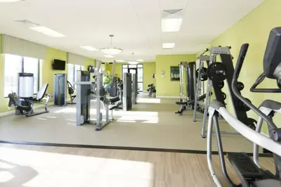 a gym with treadmills and machines in a room at Modern Apartment 2BR2BA • Near Disney • Storey Lake Resort SL47314 in Kissimmee