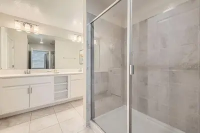 a bathroom with a glass shower and a sink at Luxurious Apartment 2BR2BA • Near Disney • PoolLazy River at Storey Lake Resort SL47315 in Kissimmee
