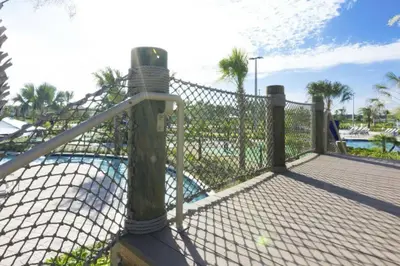 a fence next to a swimming pool with a pool at Luxurious Apartment 2BR2BA • Near Disney • PoolLazy River at Storey Lake Resort SL47315 in Kissimmee