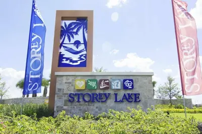 a sign for a showy lake with two flags at Exceptional Apartment 4BR3BA • Near Disney • PoolLazy River at Storey Lake Resort SL47512 in Kissimmee