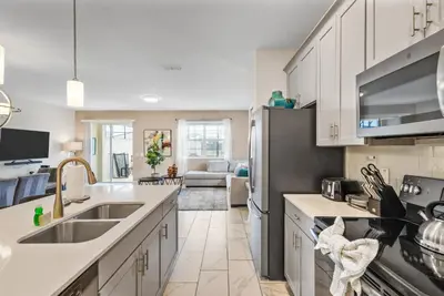 a kitchen with white cabinets and a sink at Premium 5BE4BA Home with Private Pool and Game Room Storey Lake Resort SL4839 in Kissimmee