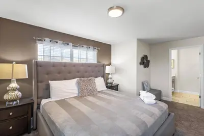 a bedroom with a large bed and a window at Premium 5BE4BA Home with Private Pool and Game Room Storey Lake Resort SL4839 in Kissimmee