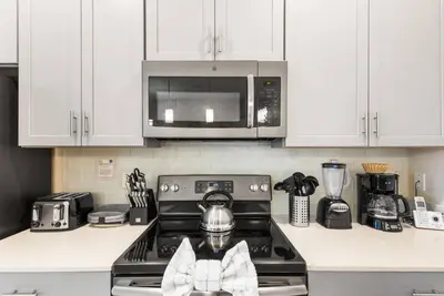 a kitchen with a stove with a tea kettle on it at Premium 5BE4BA Home with Private Pool and Game Room Storey Lake Resort SL4839 in Kissimmee