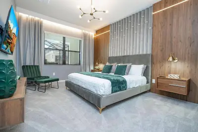 a bedroom with a bed and a desk and a chair at Brand New Top Elegance Home at Paradiso 6086 in Orlando