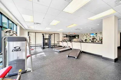 a gym with treadmills and machines in a building at Near Disney - 2BR Condo - Balcony Pool in Orlando