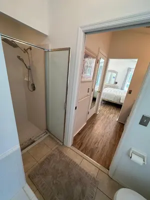 a bathroom with a shower and a glass door at Private pool with a beautiful view overlooking the lake! Near Disney - Universal in Kissimmee