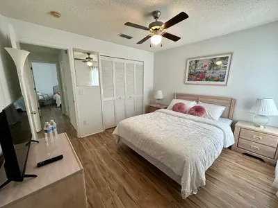 a bedroom with a bed and a ceiling fan at Private pool with a beautiful view overlooking the lake! Near Disney - Universal in Kissimmee
