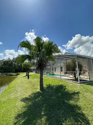 a palm tree in front of a building at Private pool with a beautiful view overlooking the lake! Near Disney - Universal in Kissimmee