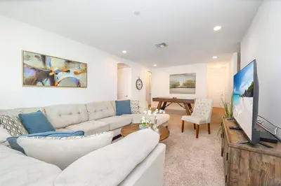 a living room with a couch and a flat screen tv at Family-Friendly Mansion at Sonoma Luxury Resort in Kissimmee