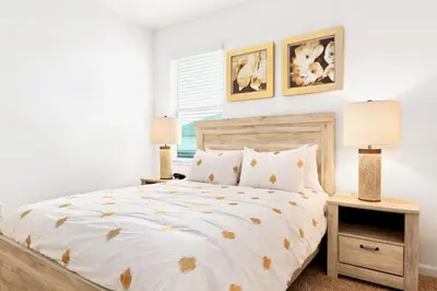 a bedroom with a bed and two lamps at Family-Friendly Mansion at Sonoma Luxury Resort in Kissimmee