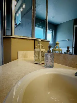 a bathroom with a sink with two candles on a counter at Its A Dream Family Vacation Rental - Minutes from Disney in Kissimmee