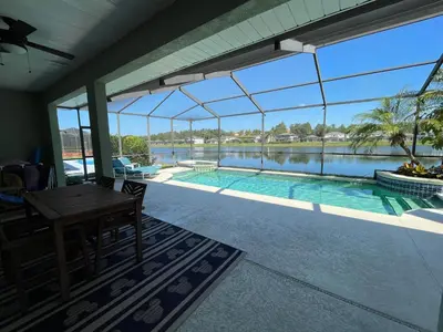 a view of a swimming pool from the patio of a house at Its A Dream Family Vacation Rental - Minutes from Disney in Kissimmee