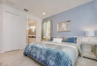 a bedroom with a large bed and a dresser at Premium Comfort - Beautiful Home Private Pool in Kissimmee